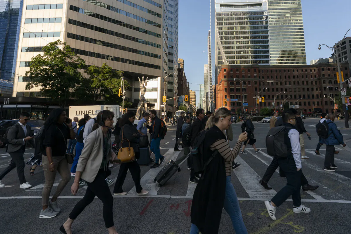 Commuters walk downtown near Union Station, in Toronto, on Aug. 22, 2024. (The Canadian Press/Paige Taylor White)