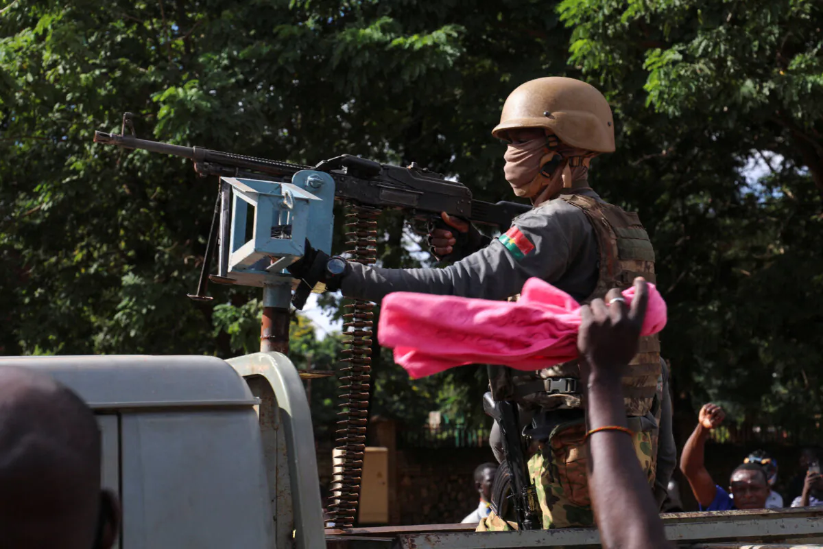 New junta's soldiers stand guard in an armoured vehicle in Ouagadougou, Burkina Faso, on Oct. 2, 2022. (Vincent Bado/Reuters)