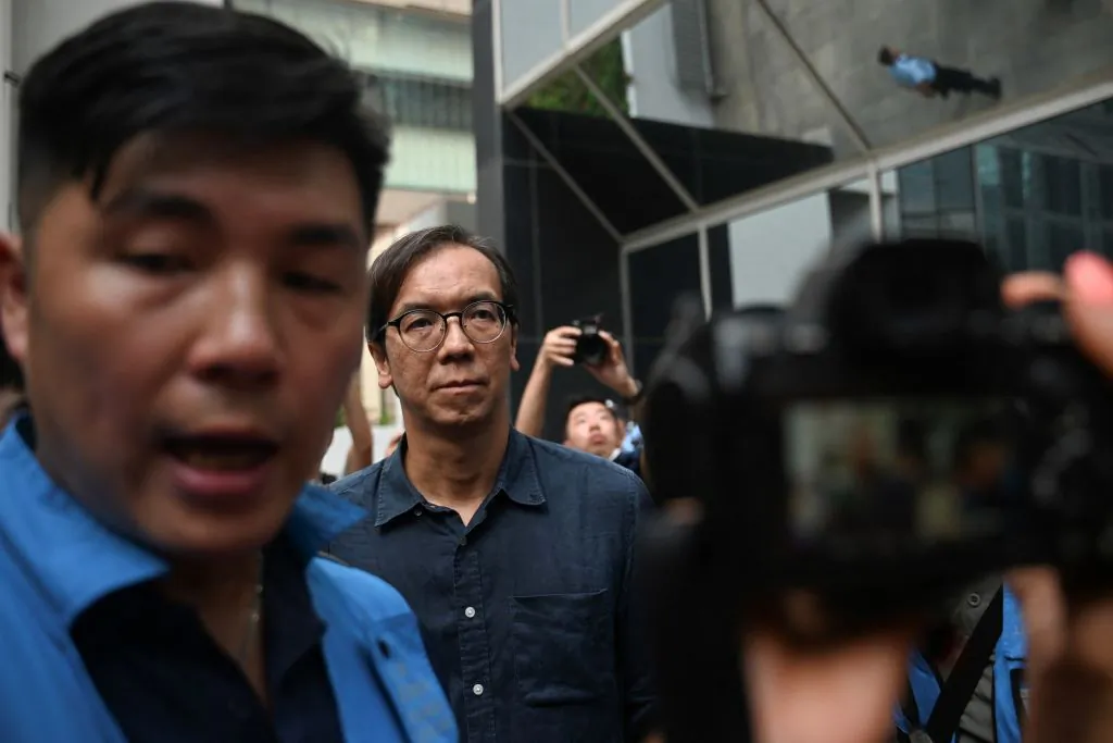 Chung Pui-kuen (C), the former chief editor of Hong Kong's now shuttered pro-democracy news outlet Stand News, leaves the district court in Hong Kong on Aug. 29, 2024, after he was found guilty of conspiracy to publish seditious publications. (PETER PARKS/AFP via Getty Images)