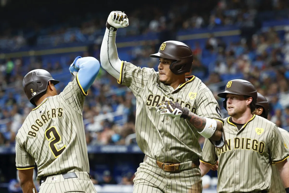 Manny Machado (13) of the San Diego Padres reacts with Xander Bogaerts (2) after hitting a three run home run during the second inning against the Tampa Bay Rays in St Petersburg, Fla., on August 30, 2024. (Douglas P. DeFelice/Getty Images)