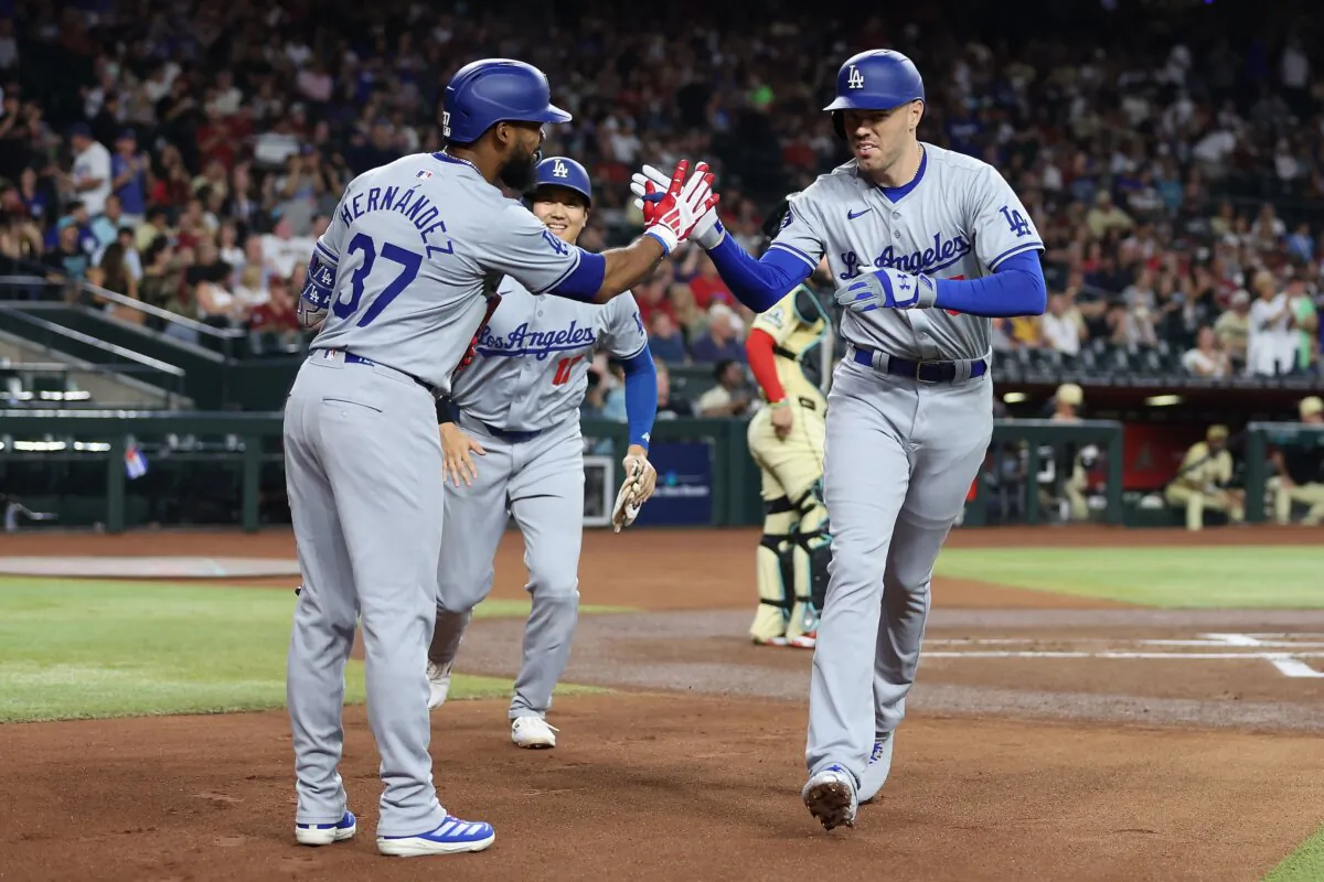 Freddie Freeman (5) of the Los Angeles Dodgers high fives Teoscar Hernández (37) and Shohei Ohtani (17) after hitting a two-run home run against the Arizona Diamondbacks during the first inning of the MLB game in Phoenix on August 30, 2024. (Christian Petersen/Getty Images)