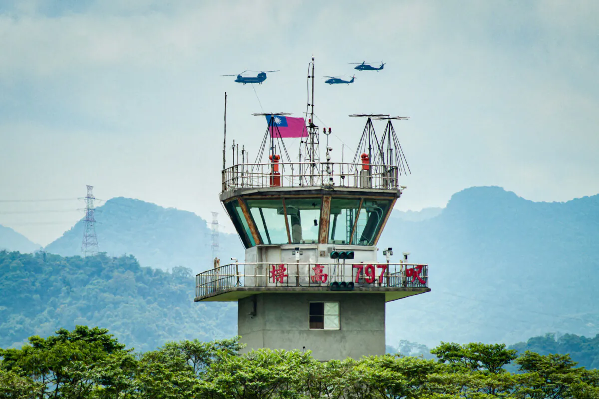 U.S.-made CH-47SD Chinook helicopters fly a Taiwanese flag past a control tower at a military base in Taoyuan, Taiwan, on May 7, 2024. (Sam Yeh/AFP via Getty Images)