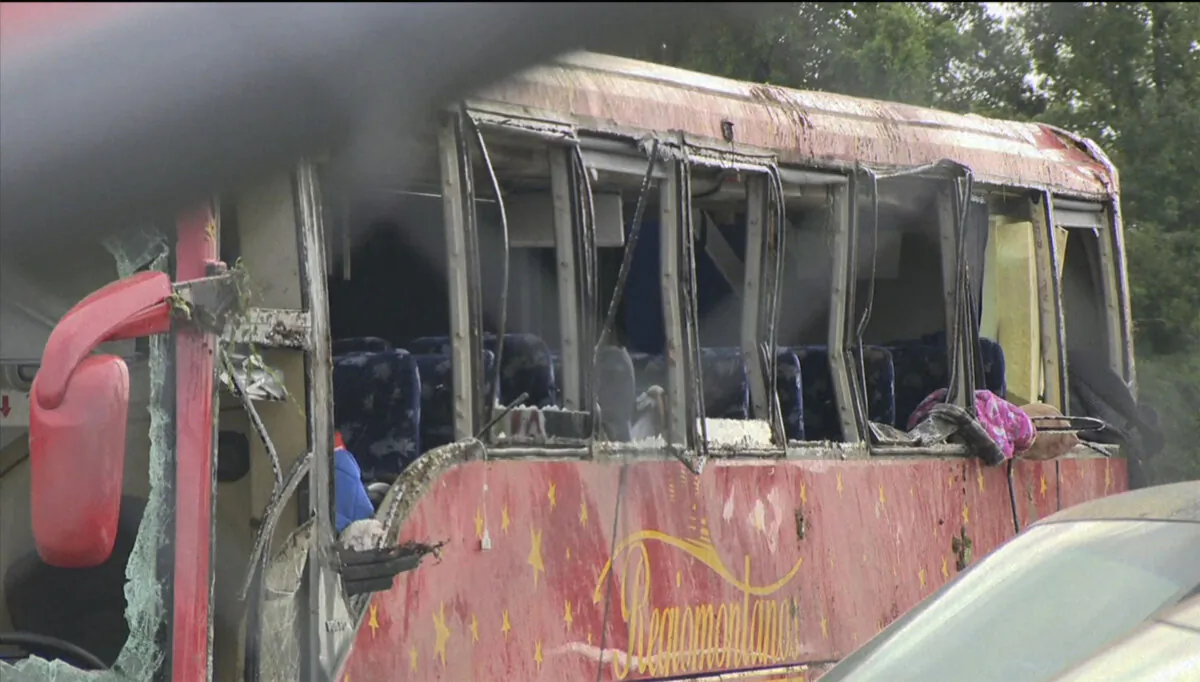 A damaged bus after several people were killed and dozens injured after the commercial bus overturned on Interstate 20 in Warren County, Miss., early on Aug. 31 2024. (WAPT via AP)