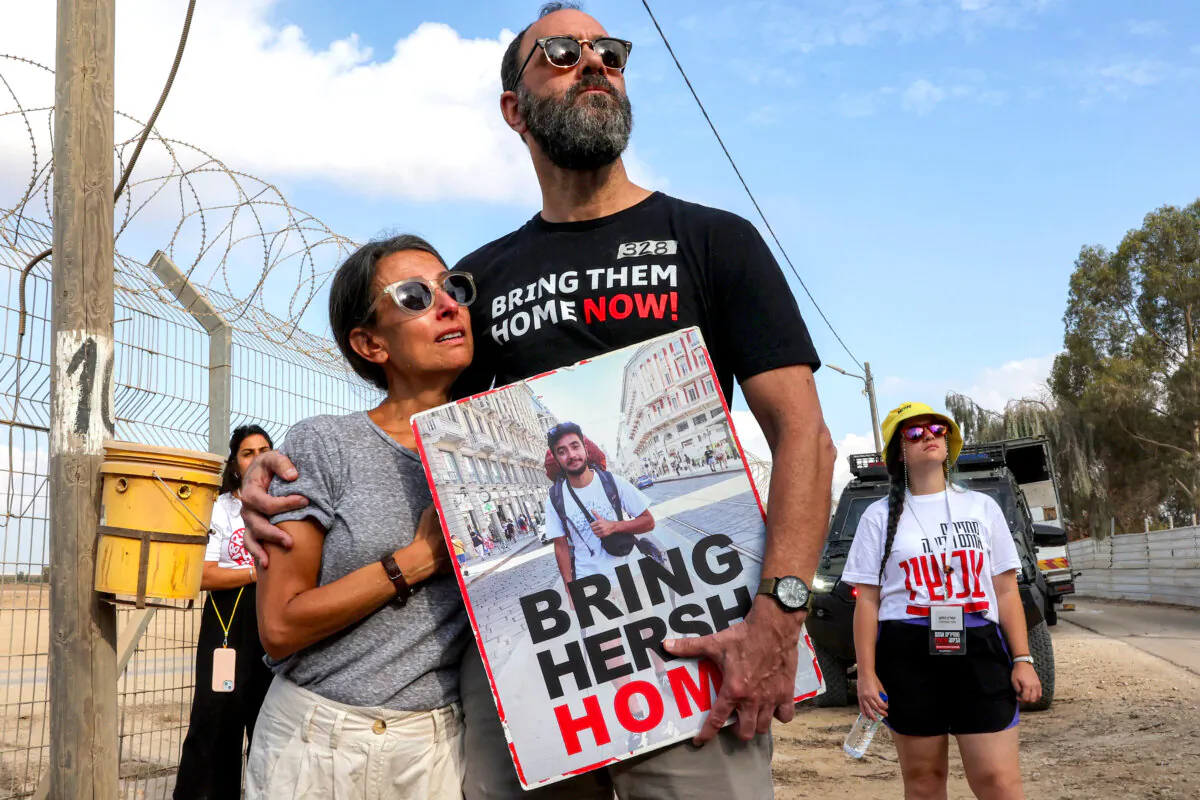 Rachel and Jon, the parents of hostage Hersh Goldberg-Polin who was kidnapped in Hamas’s Oct. 7 attack on Israel, hold their son’s photo as they call for his release, in Nirim, Israel, on Aug. 29, 2024. (Jack Guez/AFP via Getty Images)
