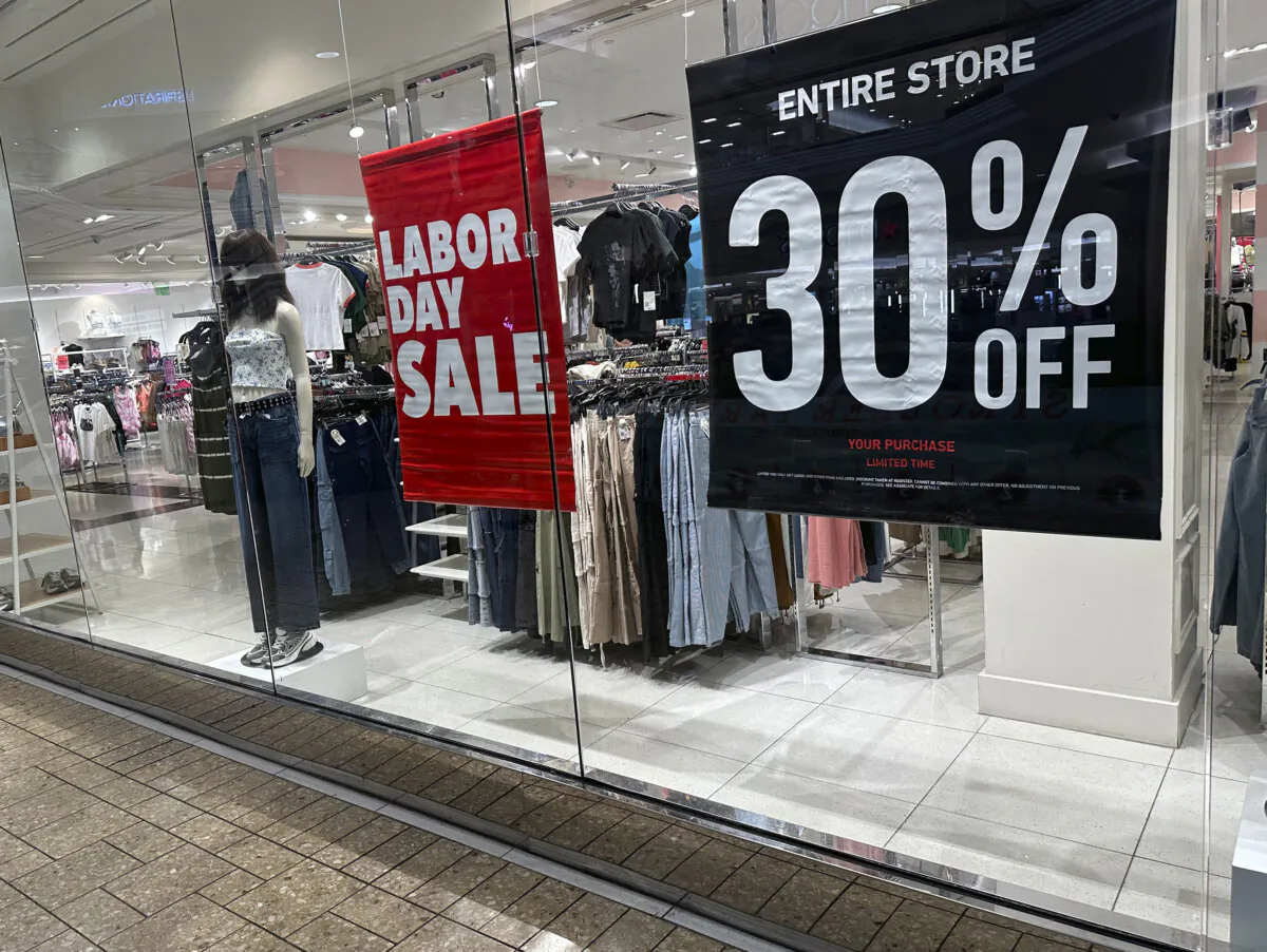 Signs announcing a Labor Day sale hang in the window of a clothing store in a mall in Denver on Aug. 21, 2024. (David Zalubowski /AP Photo)