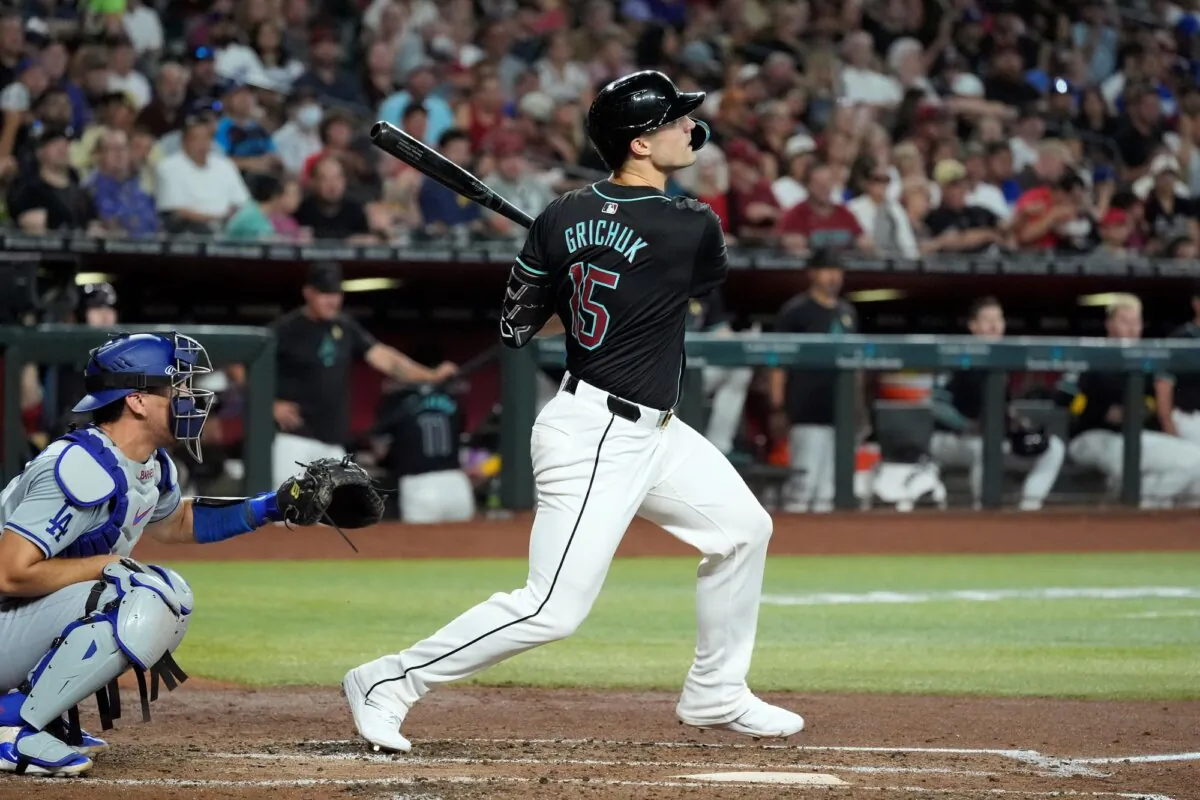 Randal Grichuk of the Arizona Diamondbacks watches the flight of his three-run home run against the Los Angeles Dodgers in Phoenix on Sept. 1, 2024. (Ross D. Franklin/AP Photo)