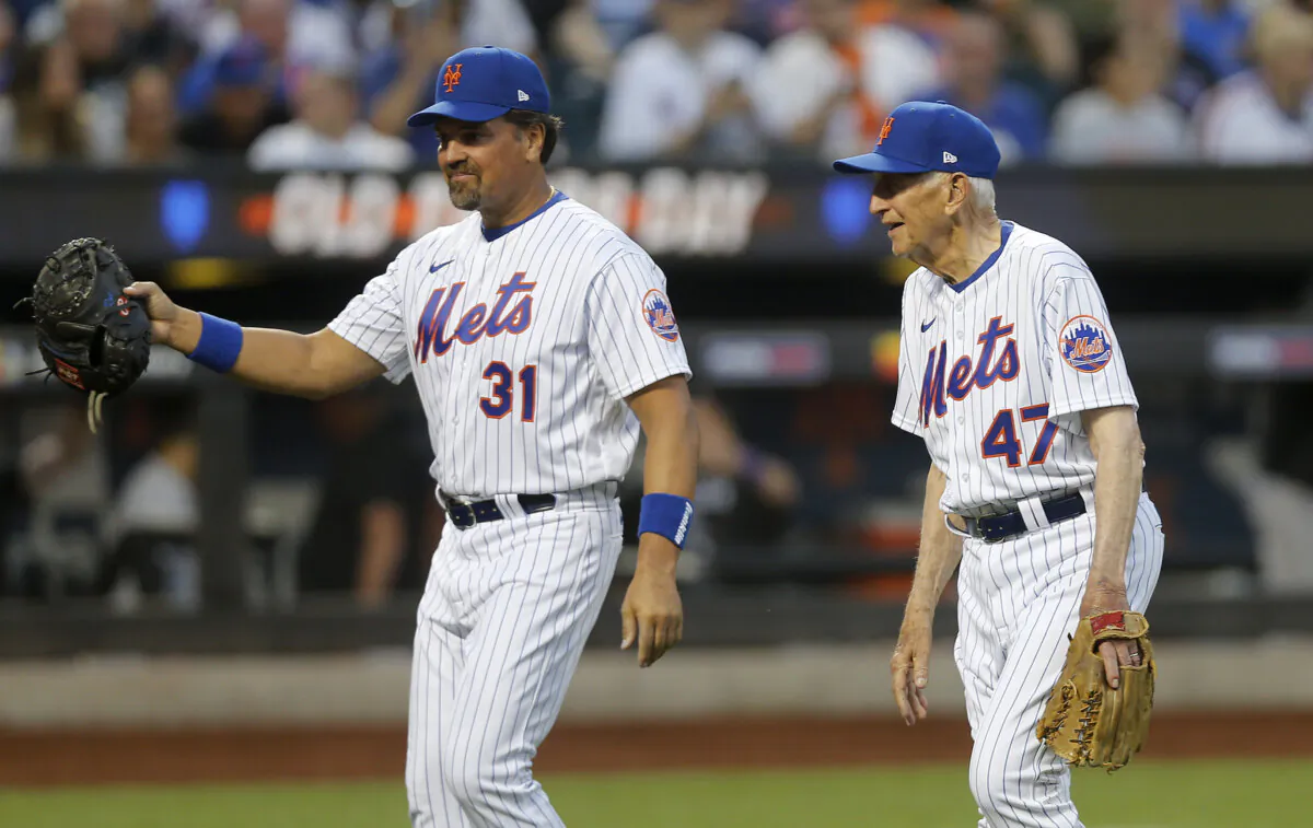 Former New York Mets Mike Piazza (31) and Jay Hook (47) walk off the field after the ceremonial first pitch before a game between the Colorado Rockies and the New York Mets at Citi Field in New York on Aug. 27, 2022. Piazza is a member of the Baseball Hall of Fame and Hook is the first winning pitcher in the team's history. (Jim McIsaac/Getty Images)