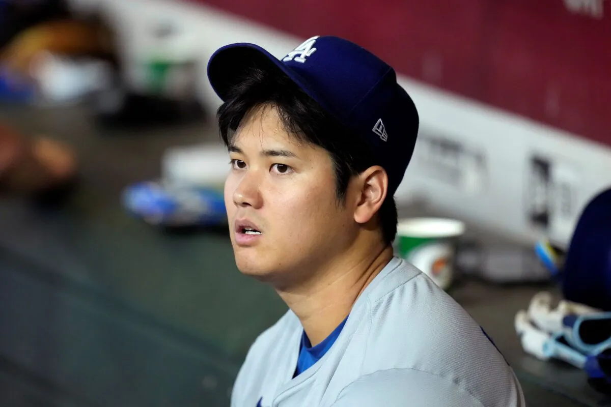 Shohei Ohtani of the Los Angeles Dodgers sits in the dugout during a game against the Arizona Diamondbacks in Phoenix on Sept. 1, 2024. (Ross D. Franklin/AP Photo)
