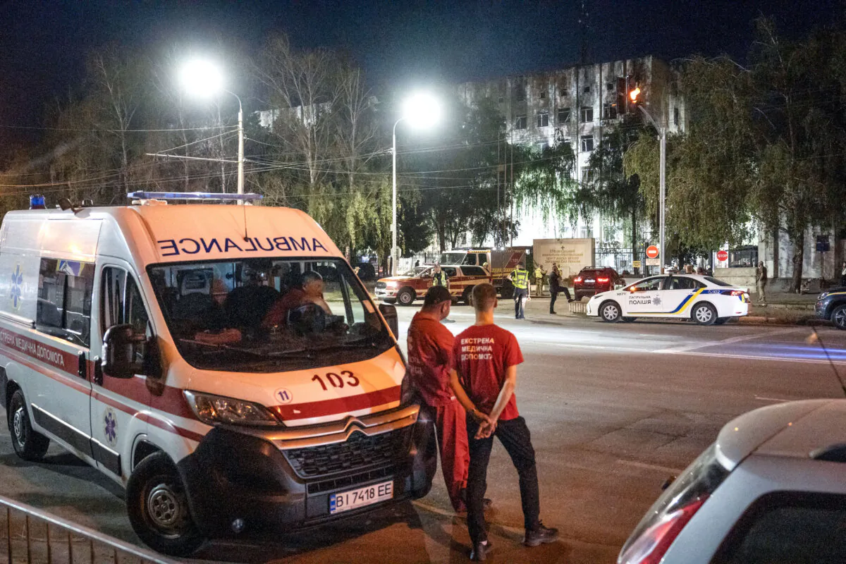 Medical workers wait outside of a military educational facility after it was hit by Russian missiles in Poltava, eastern Ukraine, on Sept. 3, 2024 (Patryk Jaraccz/AFP via Getty Images)