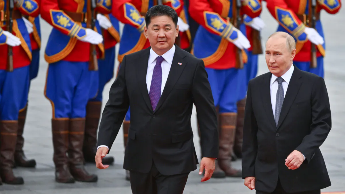 Russian President Vladimir Putin (R) walks with Mongolian President Ukhnaagiin Khurelsukh during a welcoming ceremony at Sukhbaatar Square in Ulaanbaatar, Mongolia, on Sept. 3, 2024. (Kristina Kormilitsyna, Sputnik, Kremlin Pool Photo via AP)