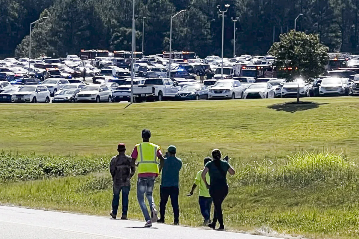 Students are evacuated to the football stadium after the school campus was placed on lockdown at Apalachee High School in Winder, Ga., on Sept. 4, 2024. (Erin Clark via AP)