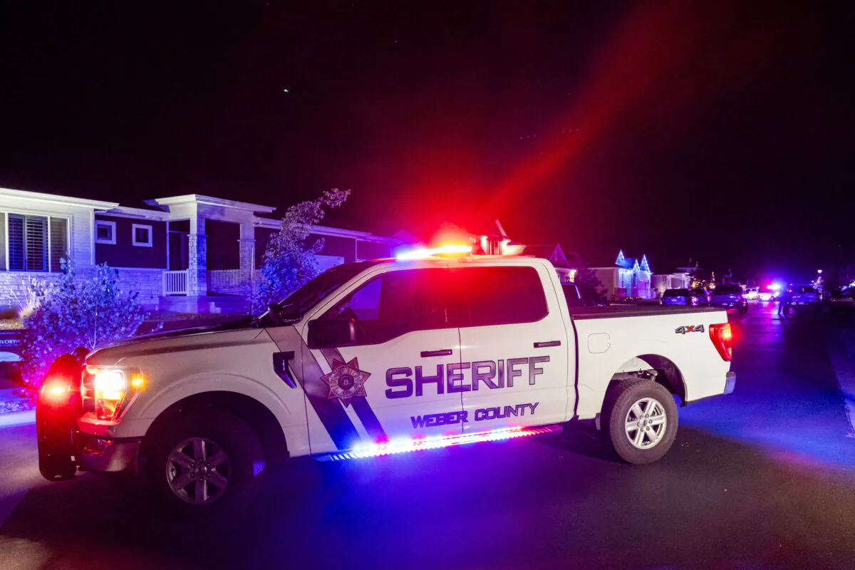 A police vehicle remains stationed at a scene where four people were found dead in West Haven, Utah, on Sept. 3, 2024. (Isaac Hale/The Deseret News via AP)