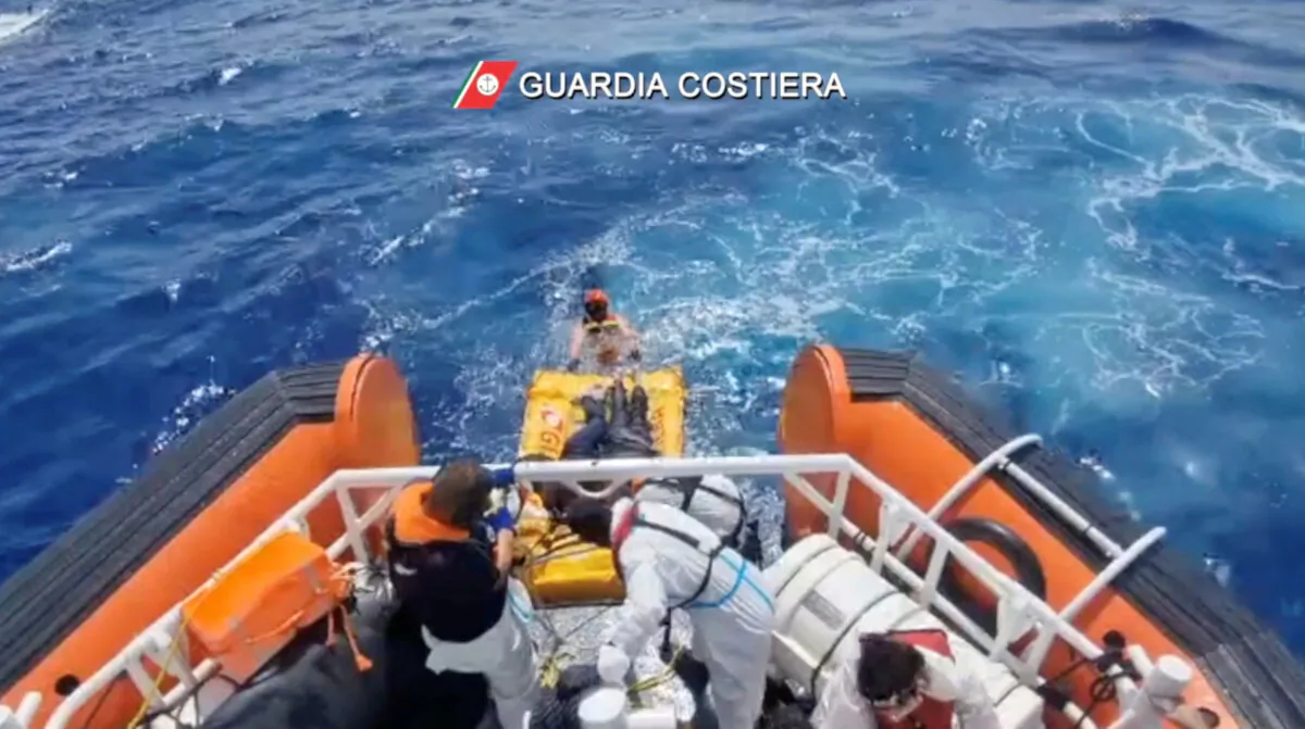 Coast guard members rescue the seven survivors of a boat that had set off from Libya a few days ago, with 28 people on board and shipwrecked near the Sicilian island of Lampedusa, Italy, on Sept. 4, 2024, in this screenshot from video. (Guardia Costiera/Handout via Reuters)