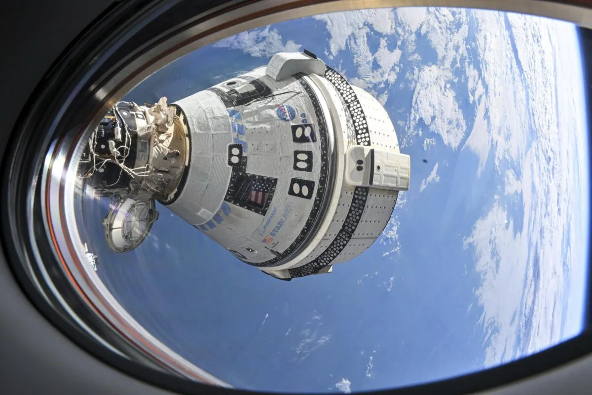Boeing's Starliner spacecraft which launched astronauts Butch Wilmore and Suni Williams to the International Space Station docked to the Harmony module's forward port on July 3, 2024, seen from a window on the SpaceX Dragon Endeavour spacecraft docked to the adjacent port. (NASA via AP)