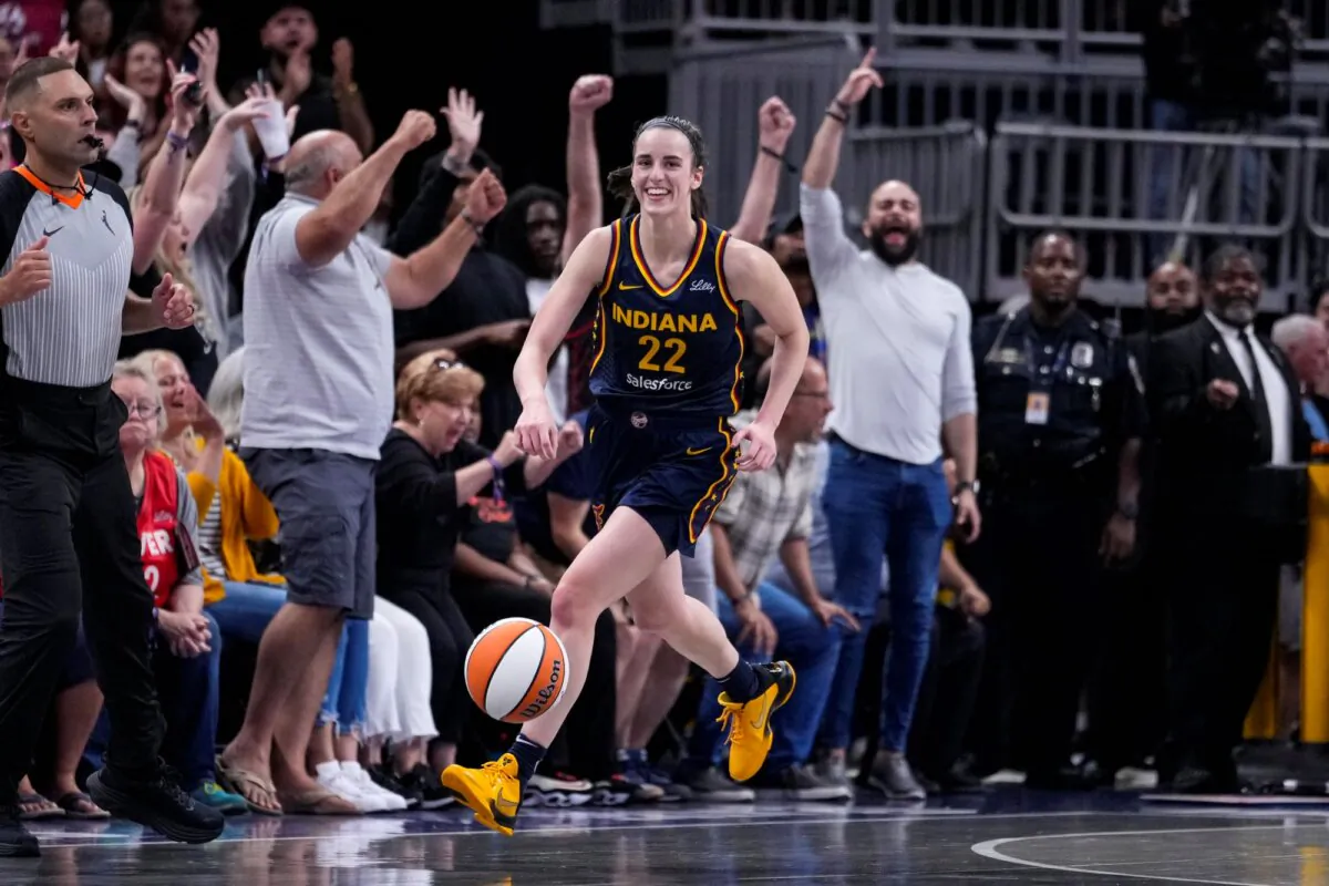 Caitlin Clark of the Indiana Fever smiles after grabbing her 10th rebound in the closing seconds against the Los Angeles Sparks to secure her second career triple-double in Indianapolis on Sept. 4, 2024. (Michael Conroy/AP Photo)