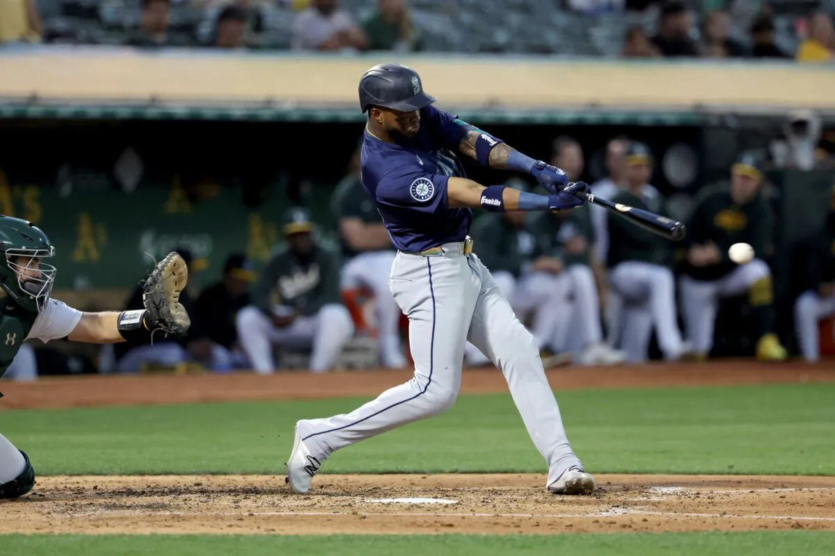 Victor Robles of the Seattle Mariners belts a double against the Oakland A's in Oakland, Calif., on Sept. 4, 2024. (Jed Jacobsohn/AP Photo)