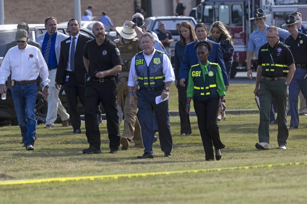 Law enforcement officials arrive to give a press conference outside of Apalachee High School in Winder, Ga., on Sept. 4, 2024. (Christian Monterrosa/AFP via Getty Images)