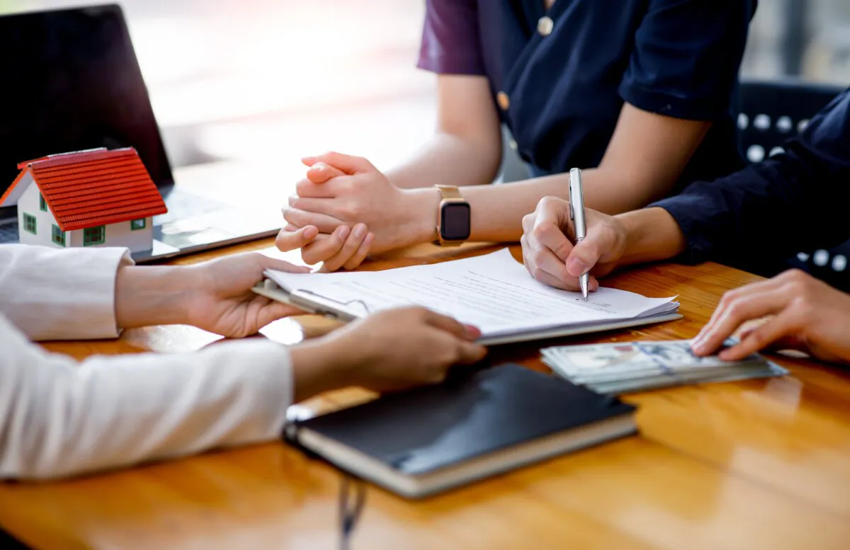 When you co-sign a loan, you tell the lending institution that you are willing to make payments even if the other person doesn't. (Shutterstock)