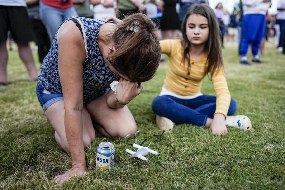 Brandy Rickaba and her daughter Emilie pray during a candlelight vigil for the slain students and teachers at Apalachee High School in Winder, Ga., on Sept. 4, 2024. (Mike Stewart/AP Photo)