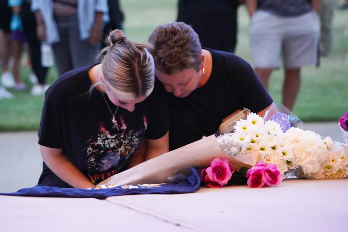 Families lay flowers as students, faculty, and community members gather for a vigil after a shooting at Apalachee High School in Winder, Ga., on Sept. 4, 2024. (Megan Varner/Getty Images)