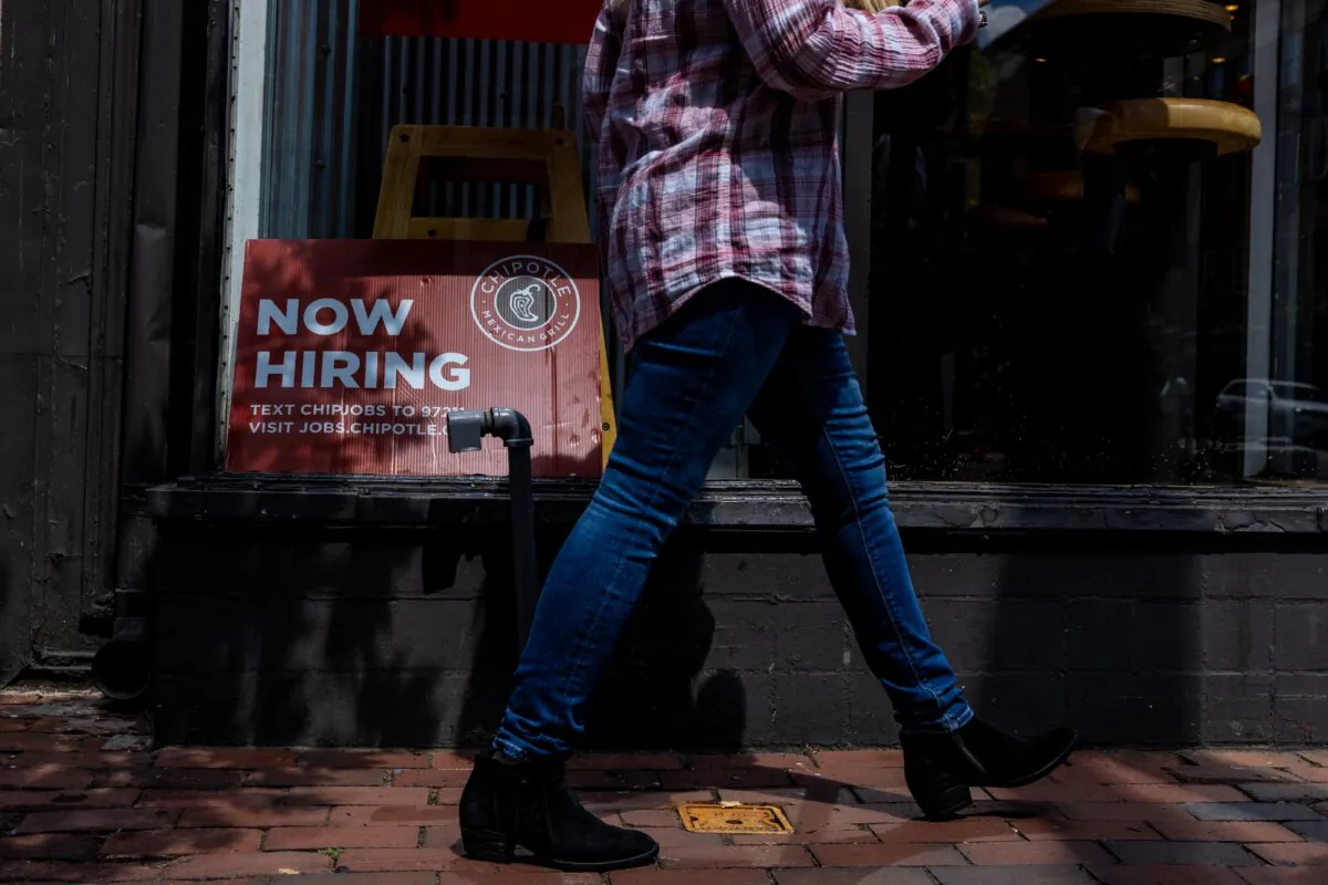 A 'Now Hiring' sign is displayed in the window of a Chipotle in Alexandria, Va., on Aug. 22, 2024. (Anna Rose Layden/Getty Images)