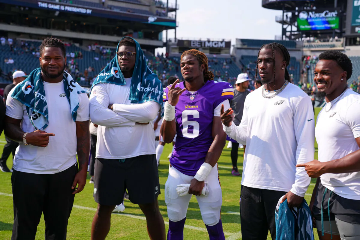 Jalen Carter, Jordan Davis, Kelee Ringo, and Nakobe Dean of the Philadelphia Eagles pose for a picture with Lewis Cine of the Minnesota Vikings after a preseason game in Philadelphia on Aug. 24, 2024. (Mitchell Leff/Getty Images)