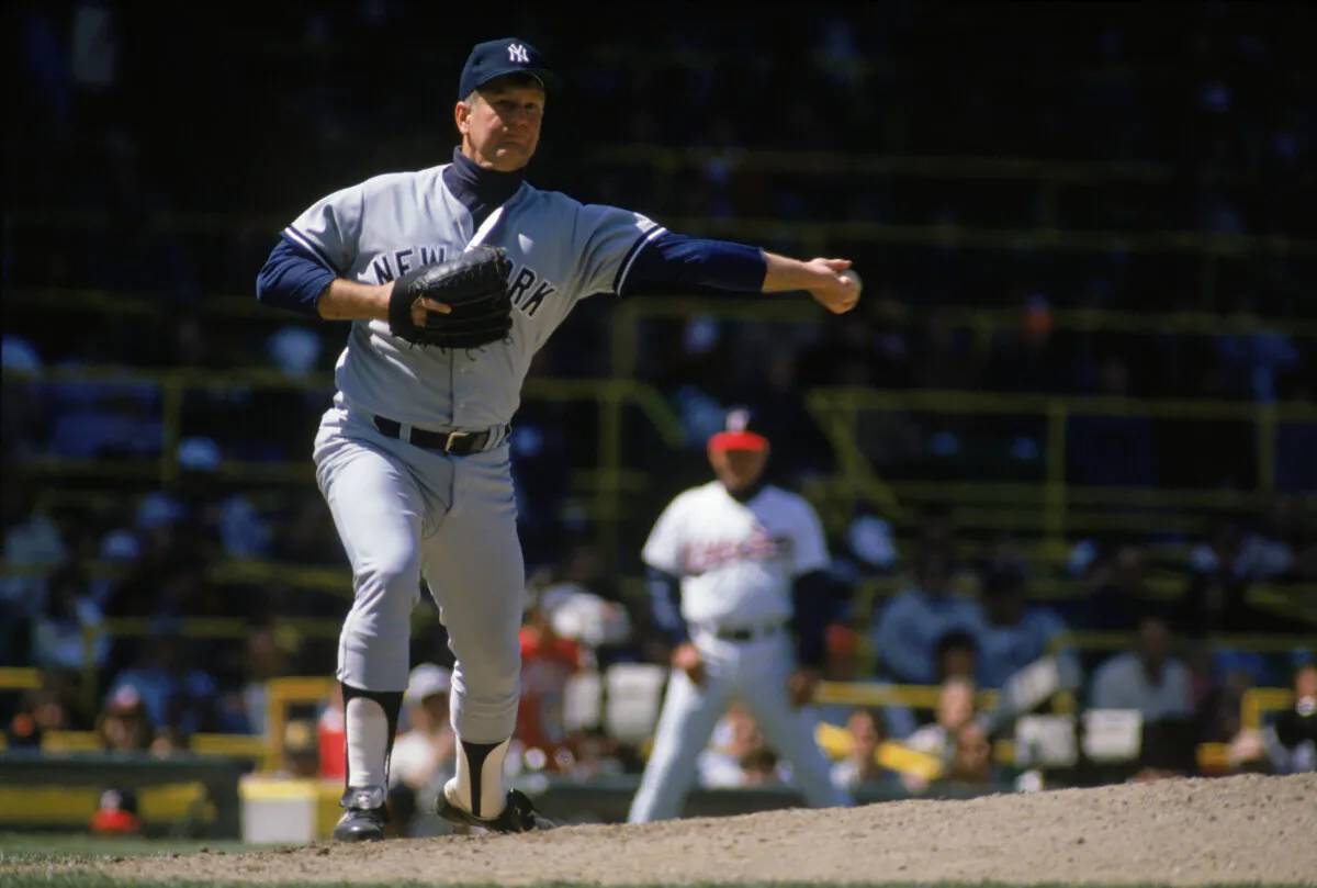 Tommy John of the New York Yankees throws to first base during a game against the Chicago White Sox at Comiskey Park in Chicago in 1989. (Jonathan Daniel/Getty Images)
