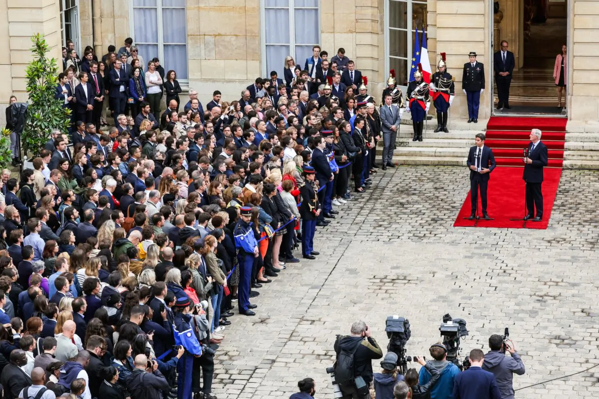France's outgoing Prime Minister Gabriel Attal (C) delivers a speech next to newly appointed Prime Minister Michel Barnier (R) during the handover ceremony at the Hotel Matignon in Paris on Sept. 5, 2024. (Geoffroy Van Der Hasselt/AFP via Getty Images)