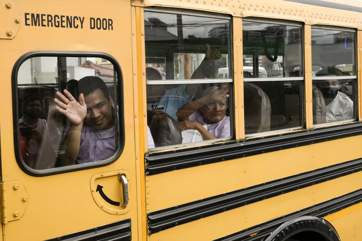 Nicaraguan citizens wave from a bus after being released from a Nicaraguan jail and landing at the airport in Guatemala City, on Sept. 5, 2024. (AP Photo/Moises Castillo)