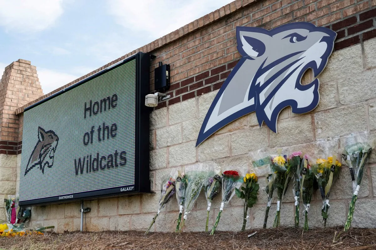 Flowers at the Apalachee High School sign the day after a fatal shooting left four dead in Winder, Ga., on Sept. 5, 2024. (Elijah Nouvelage/Reuters)