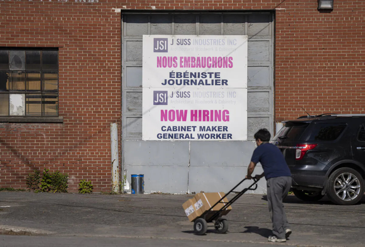 A “Now Hiring” sign for a company is displayed in Montreal in a file photo (The Canadian Press/Christinne Muschi)