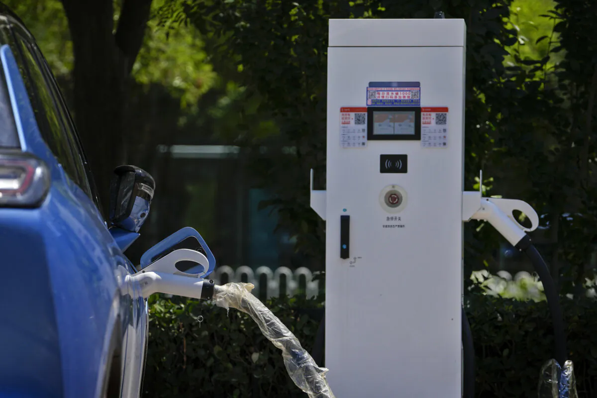 A Chinese electric vehicle charges at a  charging station in Beijing, on June 24, 2024. (AP Photo/Andy Wong)