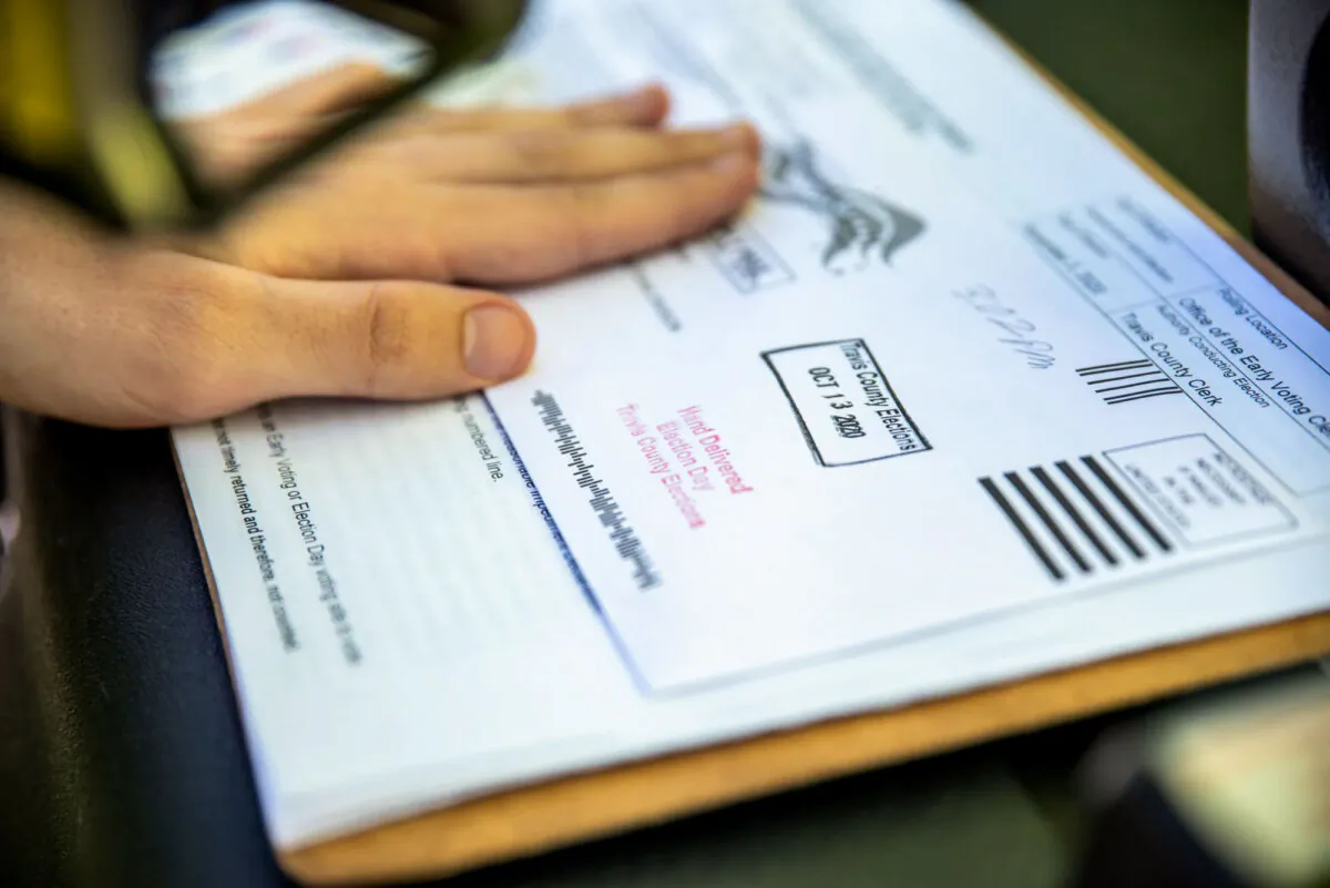 A poll worker stamps a voter's mail-in ballot in Austin, Texas, on Oct. 13, 2020. (Sergio Flores/Getty Images)