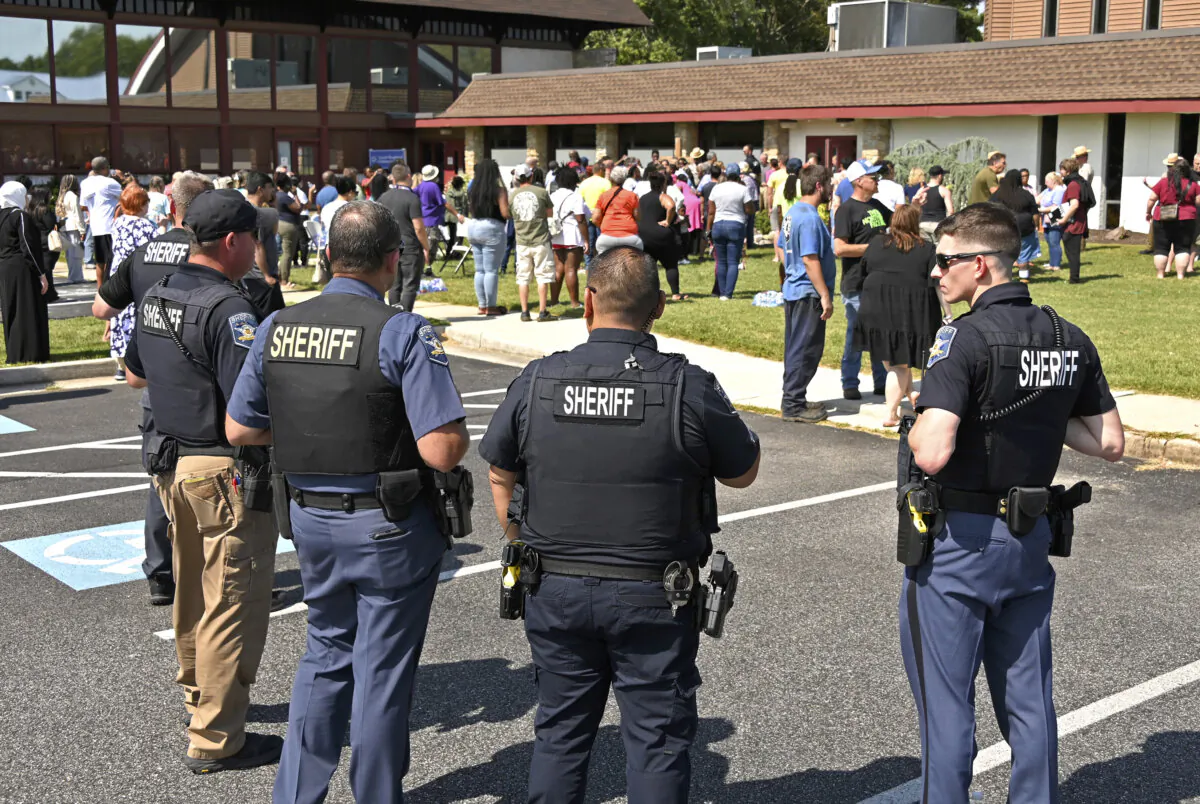 Members of the Harford County Sheriff's department stand outside of the Good Shepherd Presbyterian Church as families are reunited after students were evacuated from Joppatowne High School after a shooting at the school in Joppatowne, Md., on Sept. 6, 2024. (Lloyd Fox/The Baltimore Sun via AP)