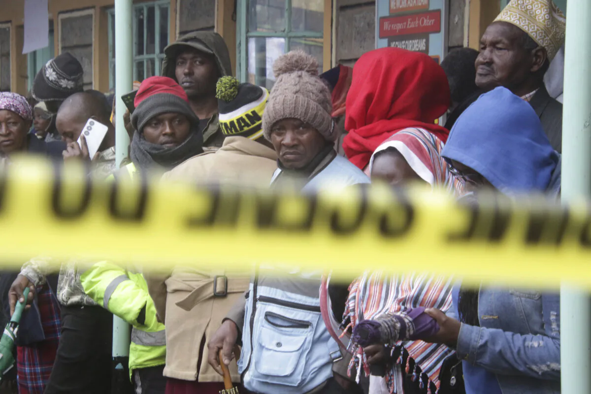 Distressed parents stand near a burnt-out dormitory, following a fire at the Hillside Endarasha Primary in Nyeri, Kenya, on Sep. 6, 2024. (AP Photo)