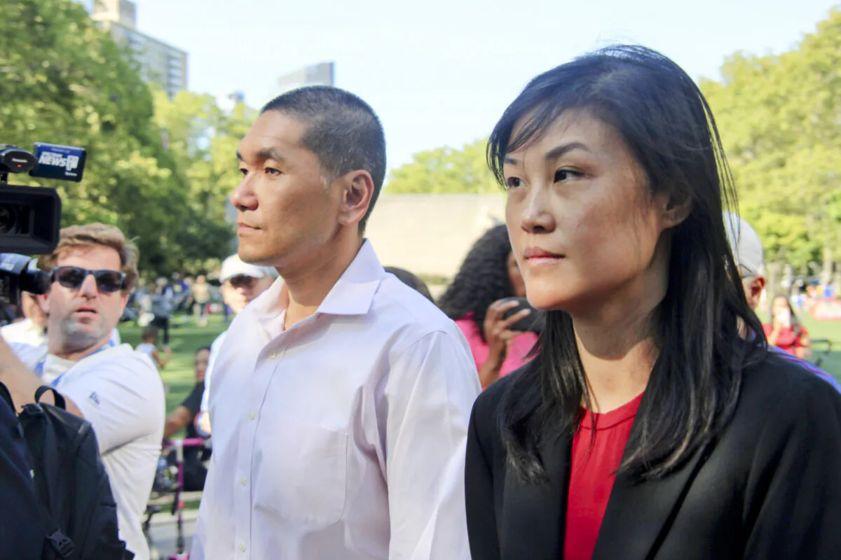 Linda Sun (R), a former aide to New York Gov. Kathy Hochul, and her husband, Chris Hu, exit the federal court in Brooklyn, New York City, on Sept. 3, 2024. (Huang Xiaotang/The Epoch Times)