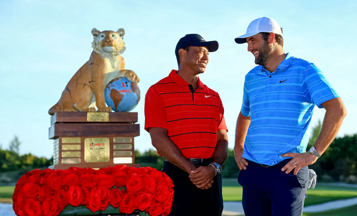 Scottie Scheffler of the United States (R) and tournament host Tiger Woods pose with the trophy after winning the final round of the Hero World Challenge at Albany Golf Course in Nassau on Dec. 3, 2023. (Mike Ehrmann/Getty Images)