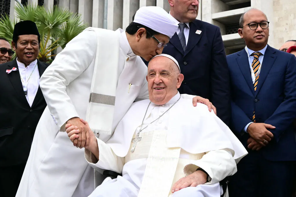 Grand Imam of Istiqlal Mosque Nasaruddin Umar (L) shakes hands with Pope Francis after an interreligious meeting with religious leaders at the Istiqlal Mosque in Jakarta on Sept. 5, 2024. (Tiziana Fabi/POOL/AFP via Getty Images)