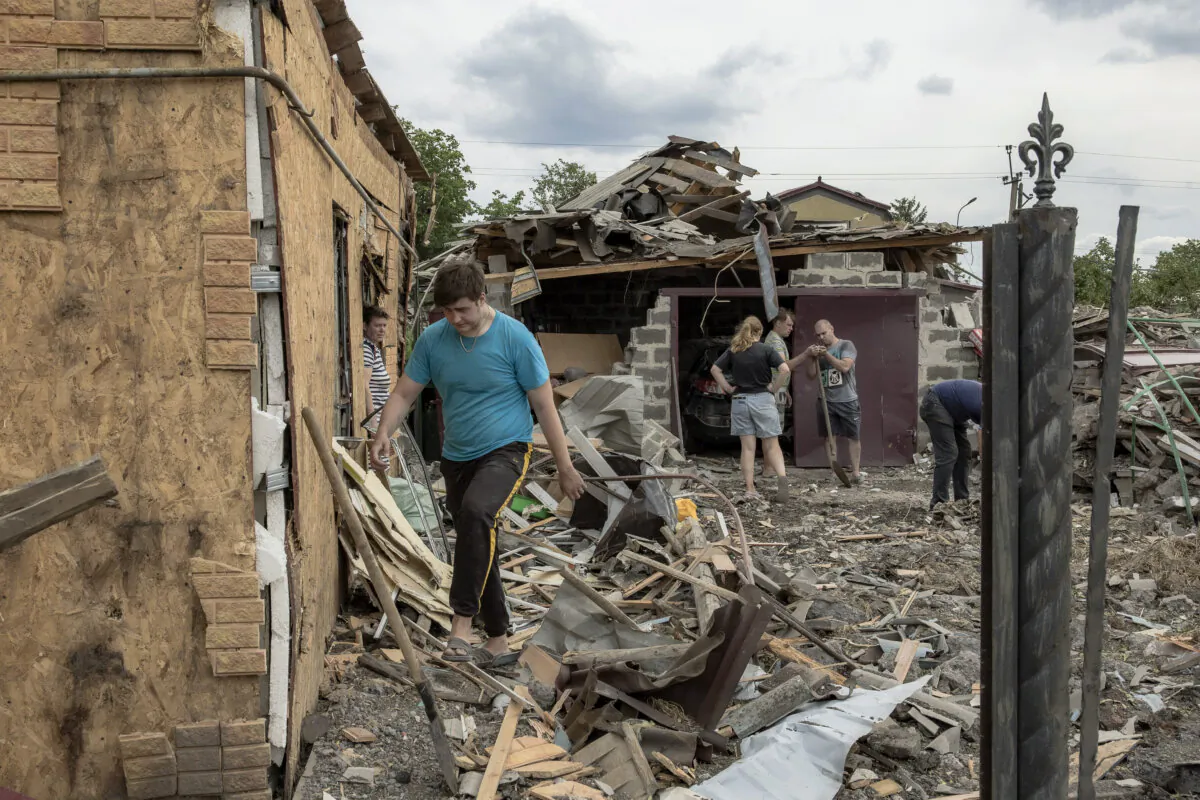 Residents clean debris next to heavily damaged houses following shelling in Pokrovsk, eastern Donetsk region, on June 24, 2024. (Roman Pilipey/AFP via Getty Images)