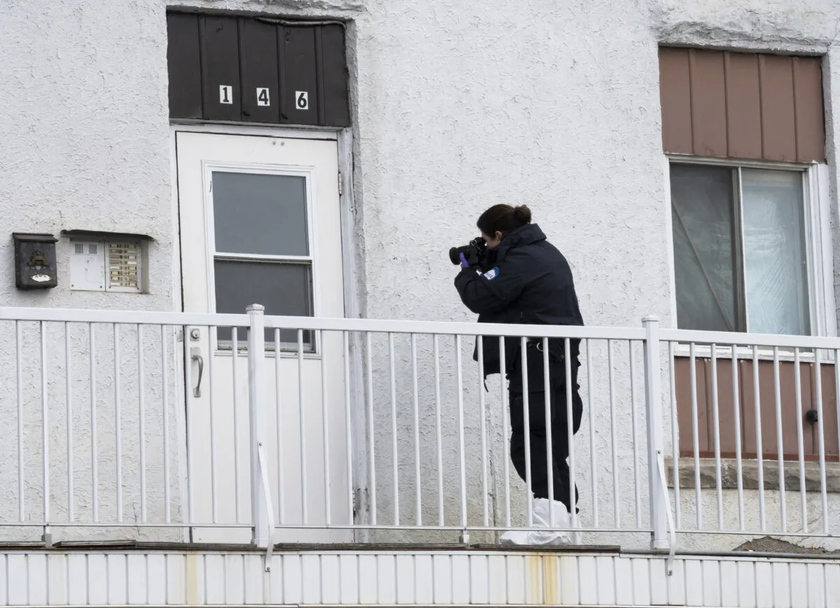 An investigator examines the scene in Louiseville, Que., on March 28, 2023. (The Canadian Press/Ryan Remiorz)