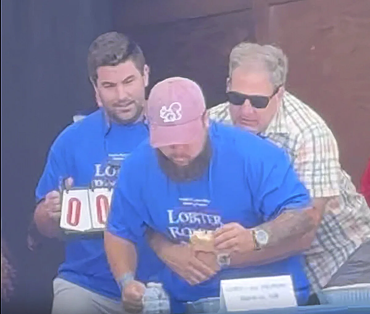 New Hampshire Gov. Chris Sununu uses the Heimlich maneuver on contestant Christian Moreno who is choking at a lobster roll eating contest at the Hampton Beach Seafood Festival in Hampton Beach, N.H., on Sept. 8, 2024. (Kateri Coffey via AP)