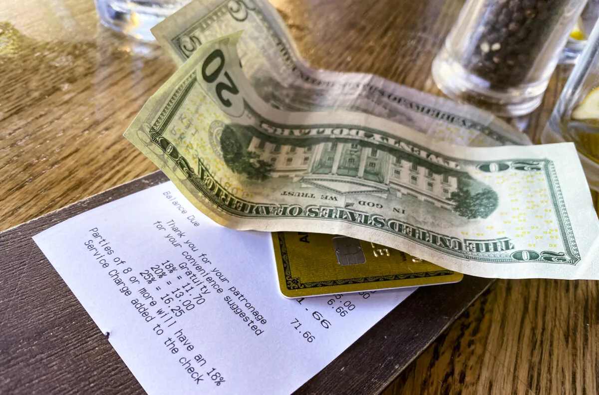 A bill, with a cash tip, is left on a restaurant table in Los Angeles on Aug. 24, 2024. (Chris Delmas/AFP via Getty Images)