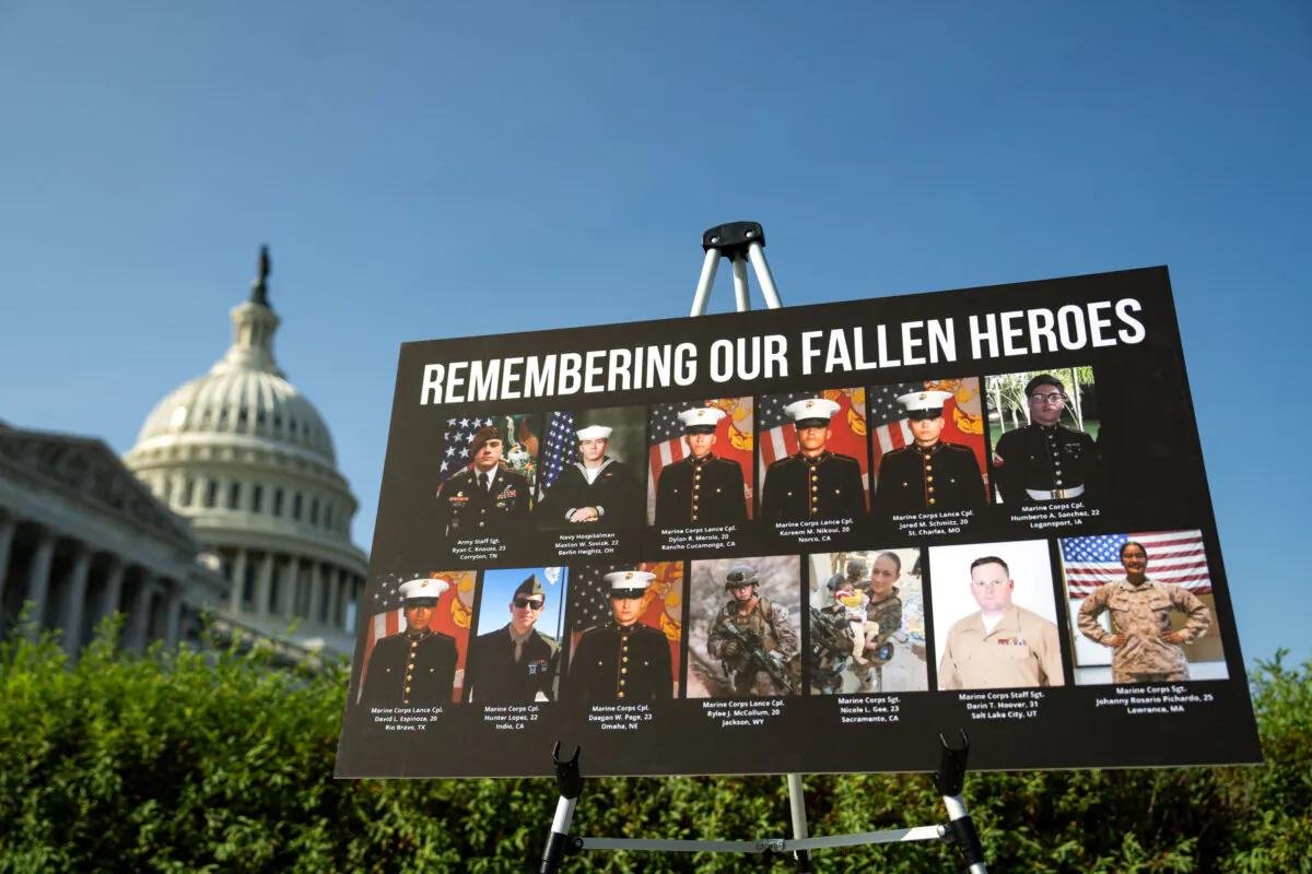 A sign displaying photos and names of the 13 service members killed in a terrorist attack at Abbey Gate outside Hamid Karzai International Airport in Kabul, Afghanistan, is seen during a news conference at the U.S. Capitol on Sept. 9, 2024. (Kent Nishimura/Getty Images)