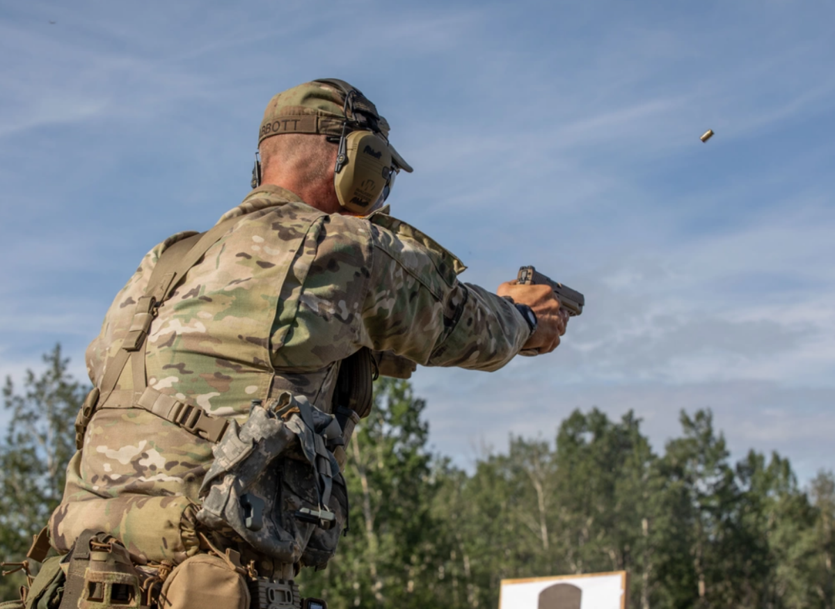 Staff Sgt. Daniel Abbott, a horizontal construction engineer with the Virginia Army National Guard, fires an M17 pistol during the 2023 Army National Guard Best Warrior Competition at Fort Greely, Alaska on July 11, 2023. (U.S. Army photo by Sgt. Kinsey Geer)