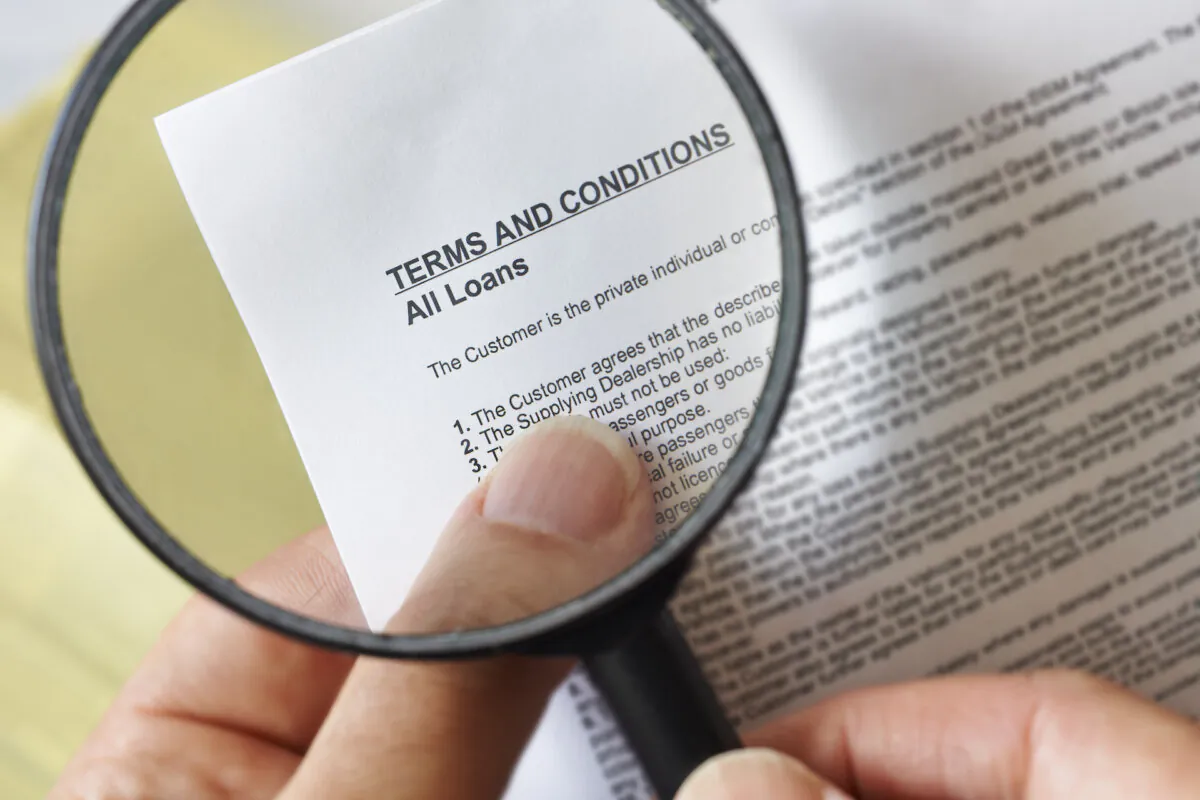 Reading the fine print can save you from unexpected pitfalls. (gemphoto/Shutterstock)
