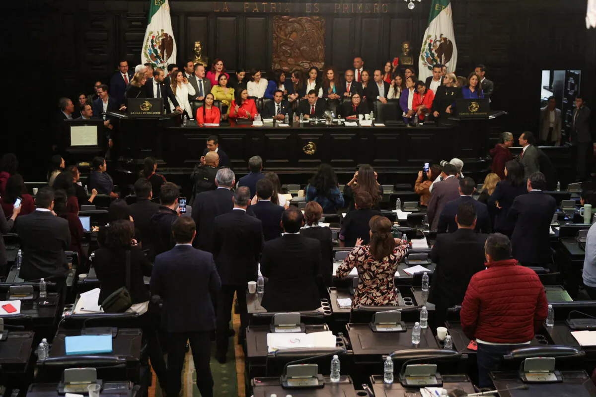 Opposition senators protest behind the executive table during a debate on judicial reforms in the Senate building in Mexico City on Sept. 10, 2024. (Luis Cortes/Reuters)
