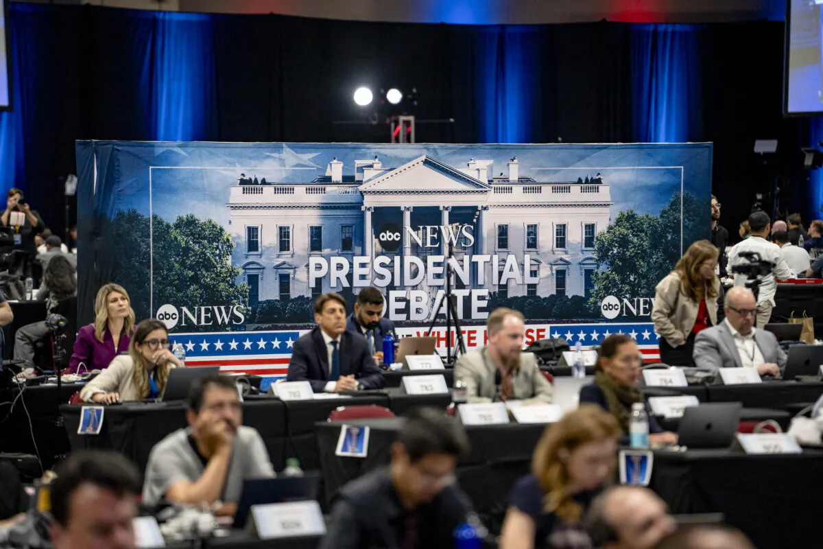 Members of the press watch the presidential debate between former President Donald Trump and Vice President Kamala Harris in Philadelphia on Sept. 10, 2024. (Madalina Vasiliu/The Epoch Times)