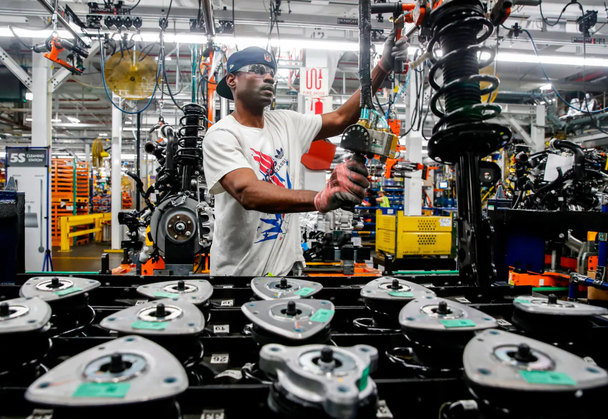 Workers assemble cars at Ford's newly renovated Chicago Assembly Plant on June 24, 2019. (Jim Young/AFP via Getty Images)