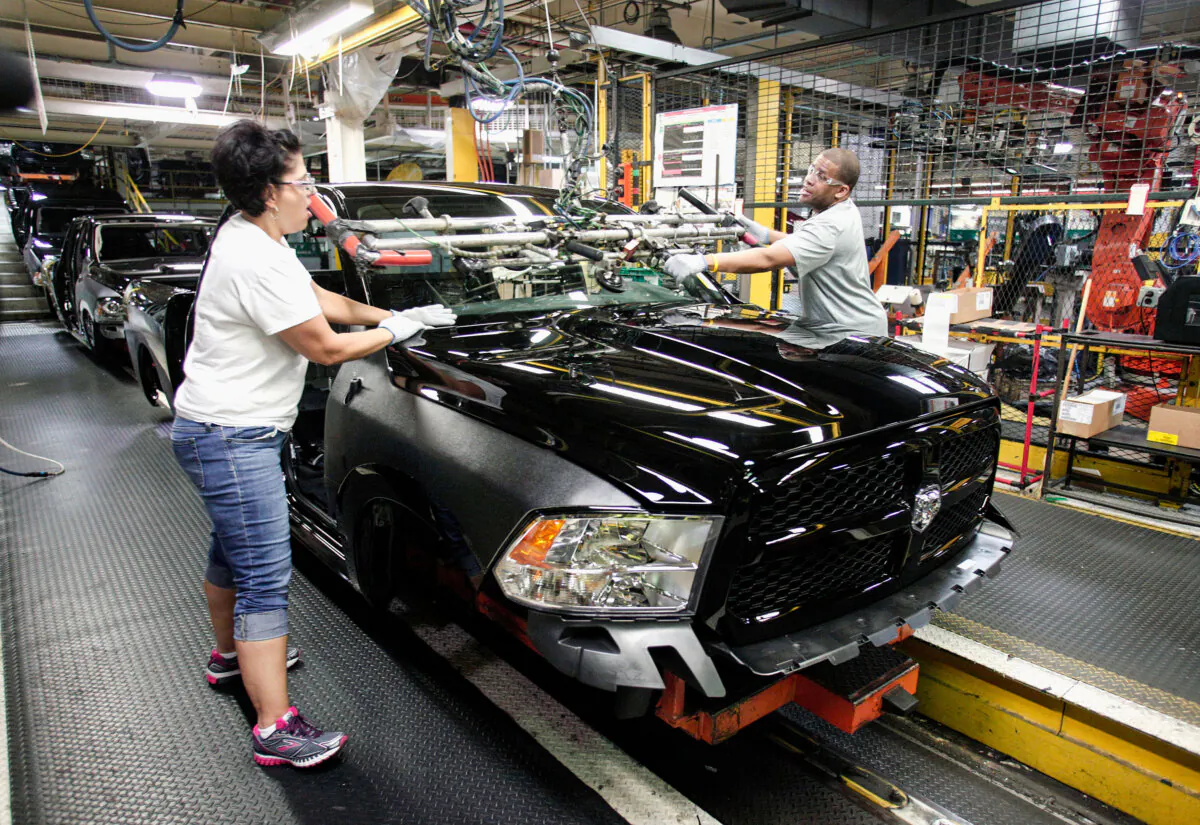 Workers install a windshield into a Ram 1500 truck on the assembly line at the Warren Truck Assembly Plant in Warren, Mich., in a file photo. (Bill Pugliano/Getty Images)