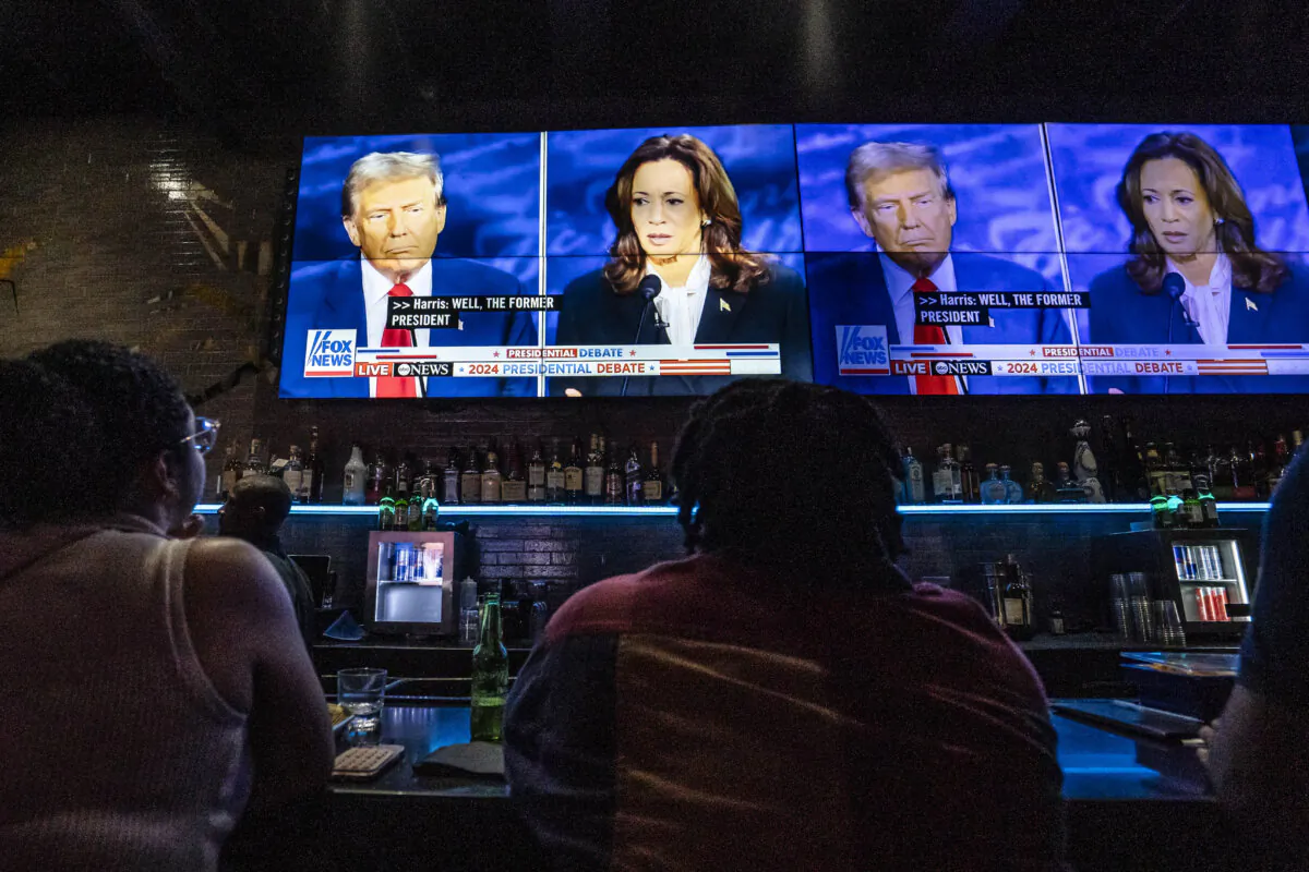 People watch the presidential debate between Vice President Kamala Harris and former President Donald Trump, at a watch party at the Slate bar and lounge in New York City on Sept. 10, 2024. (Samira Bouaou/The Epoch Times)
